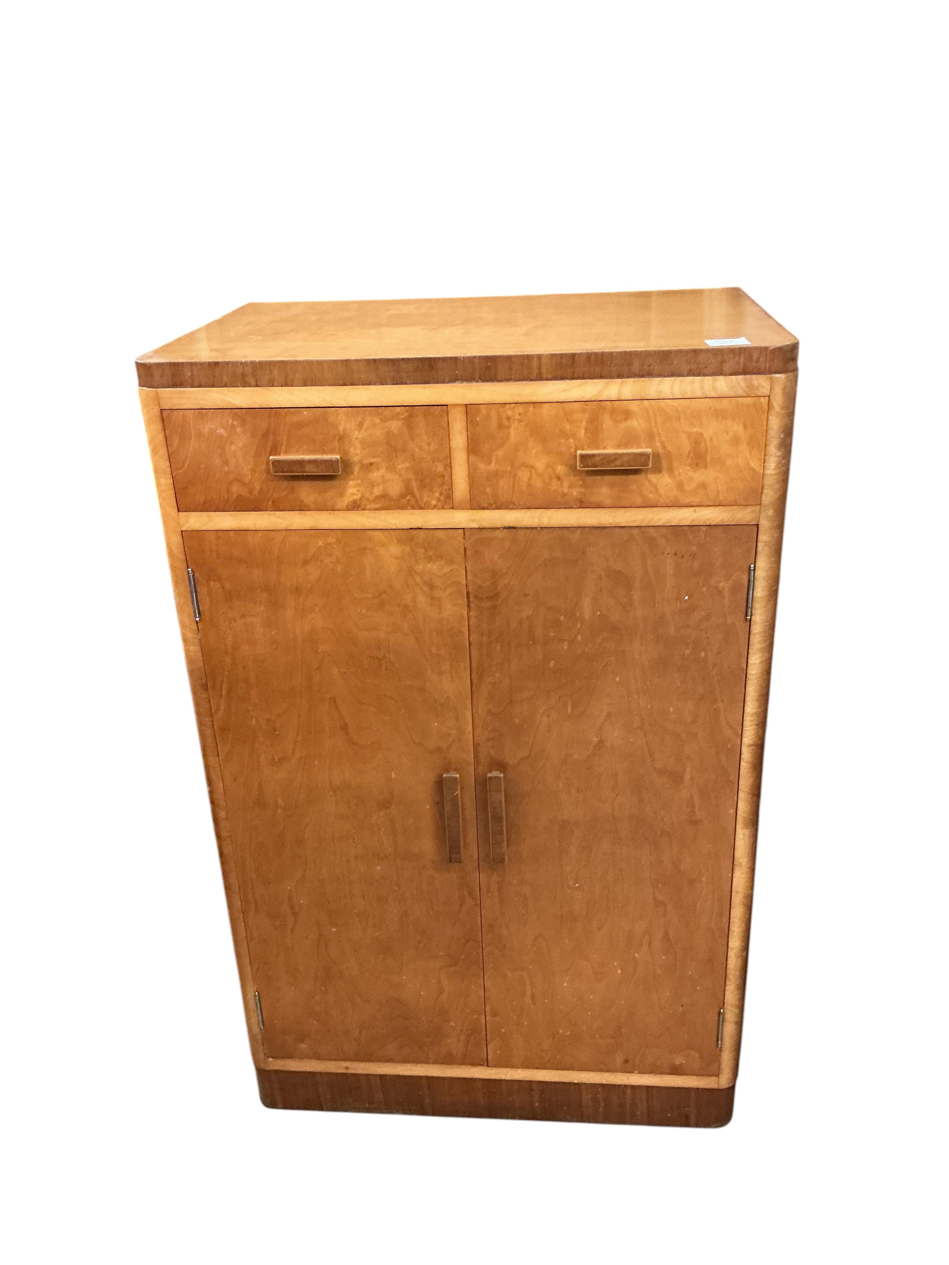 An early 20th century maple two drawer press cupboard, width 68cm, depth 45cm, height 107cm